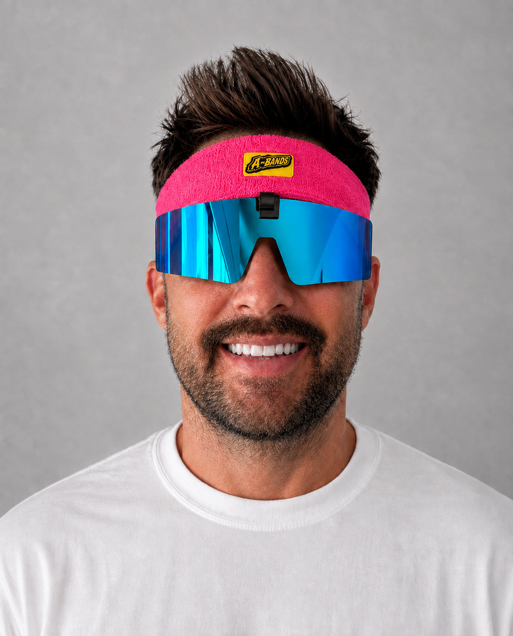 Man wearing A-BANDS pink headband with blue mirrored flip-up lenses, front view